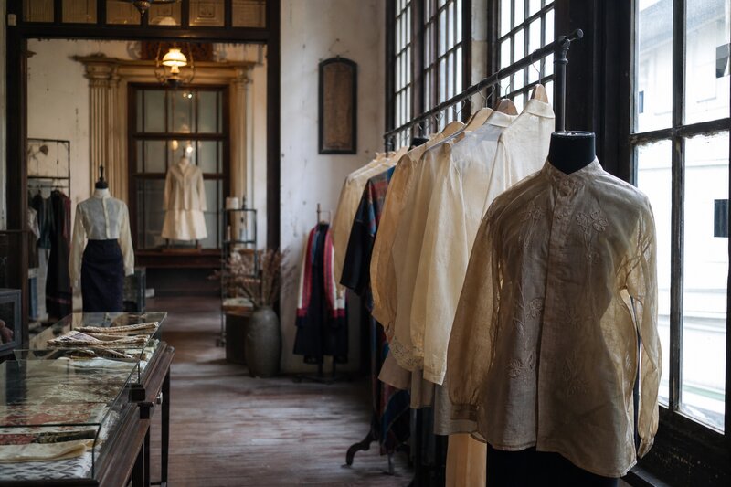 A curated vintage boutique inside a historic Escolta heritage building with barongs on display