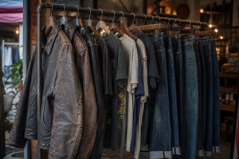 A curated rack of vintage leather jackets, band tees, and denim in a Manila vintage store